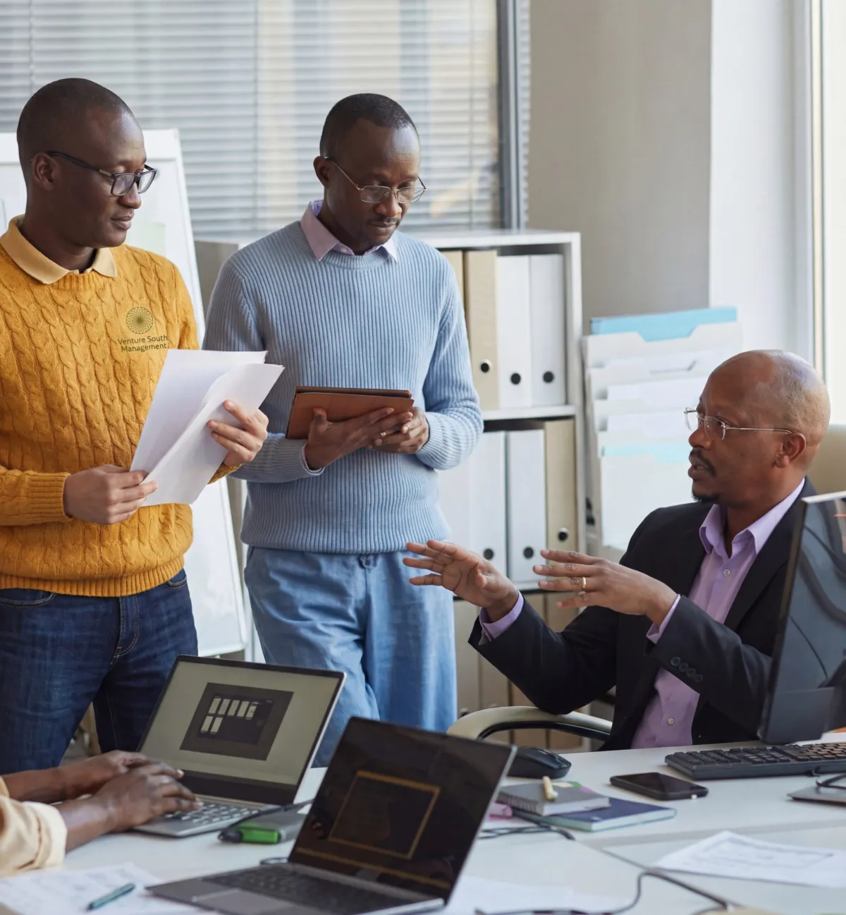 Team discussing documents in an office